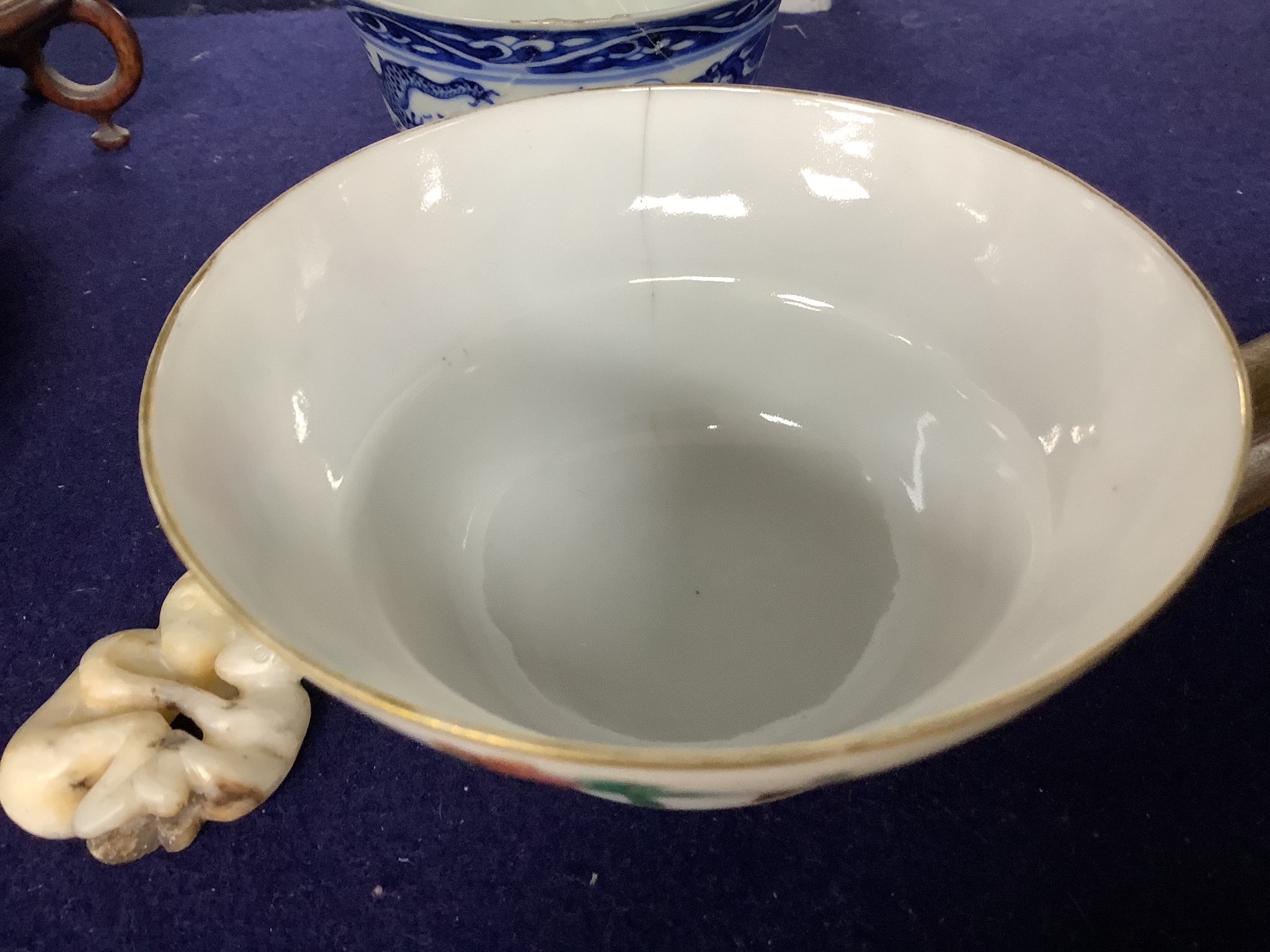 A 19th century famille rose bowl and stand, a blue and white cup, a famille rose jar and a stone carving of two monkeys